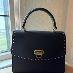 Small black gently used handbag bronze hardware