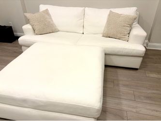 Couch with large ottoman and 2 throw pillows