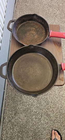 Tramontina Pre-Seasoned Cast Iron Skillets with removable red silicone handle grips.