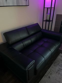 Two seater black leather couch