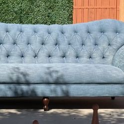 Tufted back designer looking teal sofa