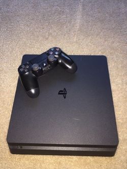 playstation, black with cords and controller
