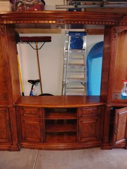 Entertainment center or shelves around Double bed.