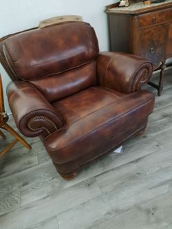 One brown leather wide chair.