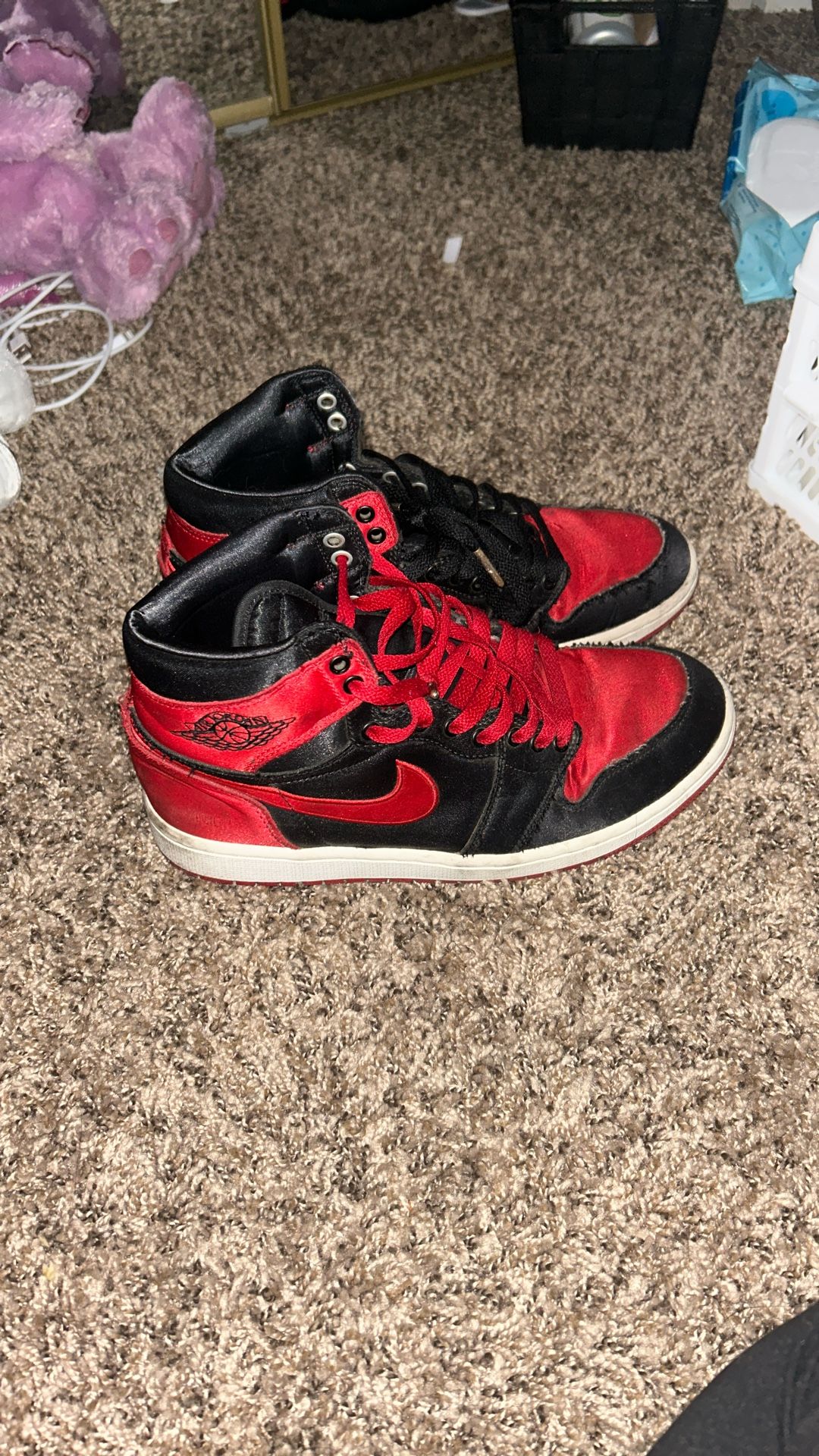This is a pair of Nike Air Jordan 1 Retro High OG "Satin Bred" sneaker