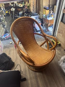 A 1980s rattan sculptural swivel lounge chair with woven seat