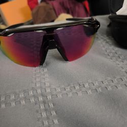 These are Oakley Radar EV Path sunglasses, featuring a polished black frame and interchangeable Prizm Road lenses.