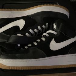 Nike Air Force 1 mid sneakers black suede upper with white Swooshes and a classic gum rubber outsole