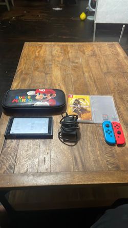 Nintendo switch with a carrying case and charger and mortal kombat and Zelda