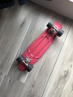 Pink penny board with blue wheels