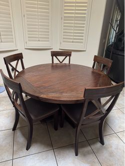 Dark wood round dinner table