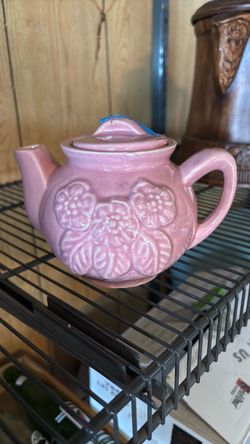 Vintage pink tea pot with flowers.