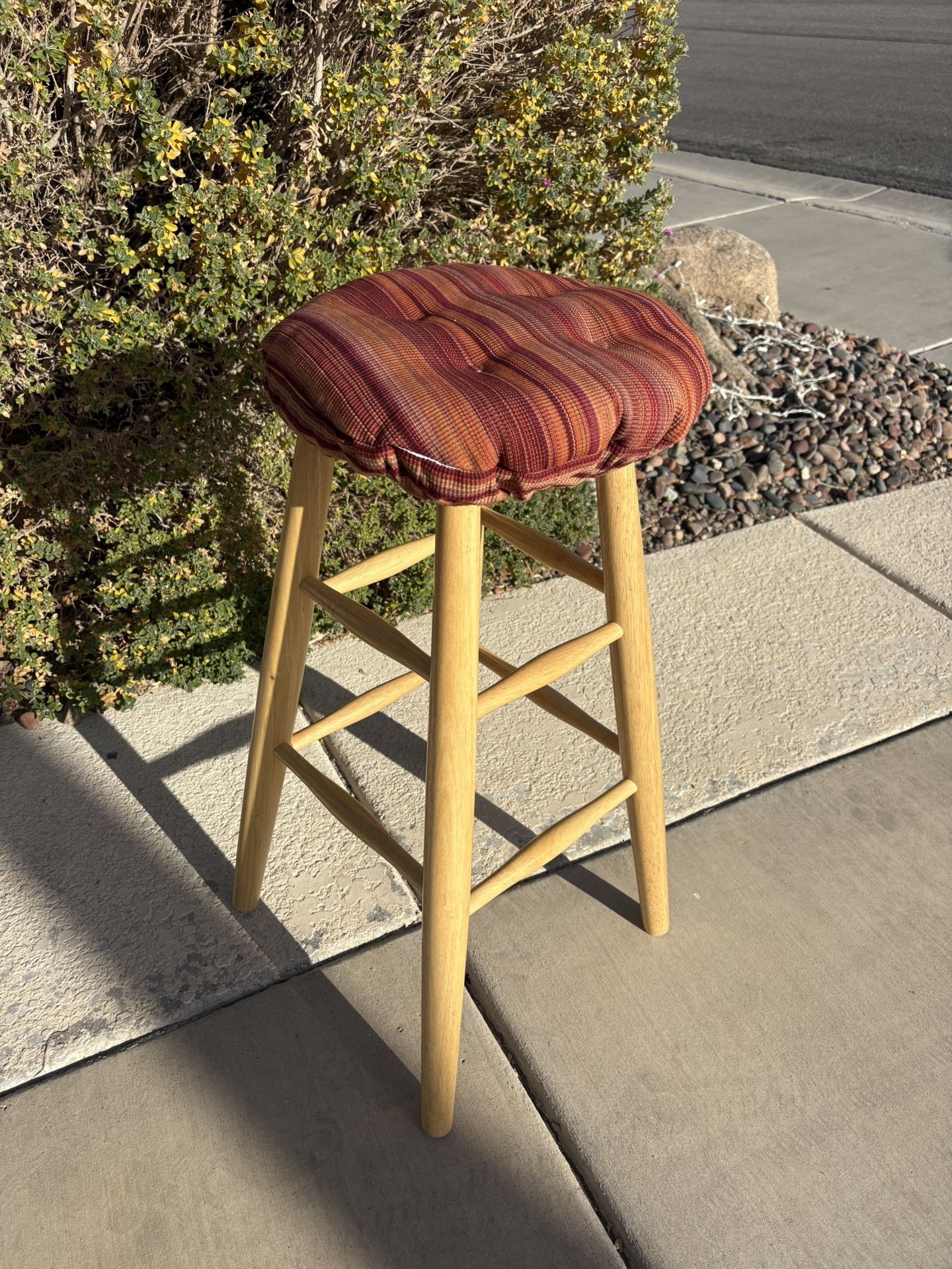 This is a wooden bar stool with a Klear Vu Omega tufted barstool cushion.