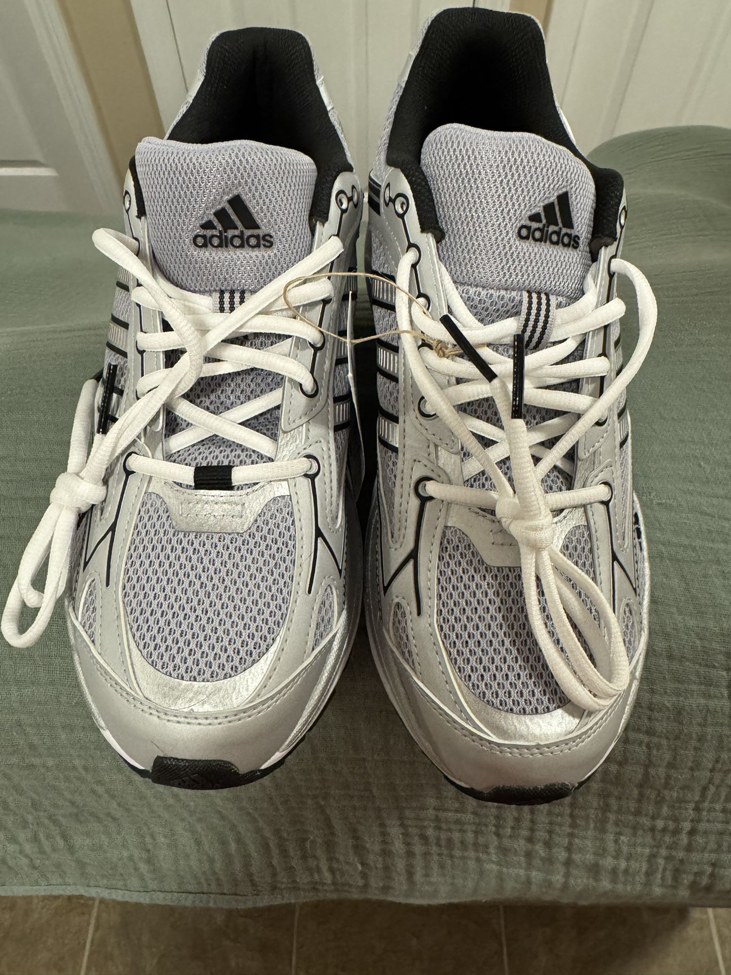 Brand new with tags, Adidas Spiritain 2000 sneakers. White and Silver. Very nice for the warmer weather. These are size 10.5 Men’s or 12 Women’s.