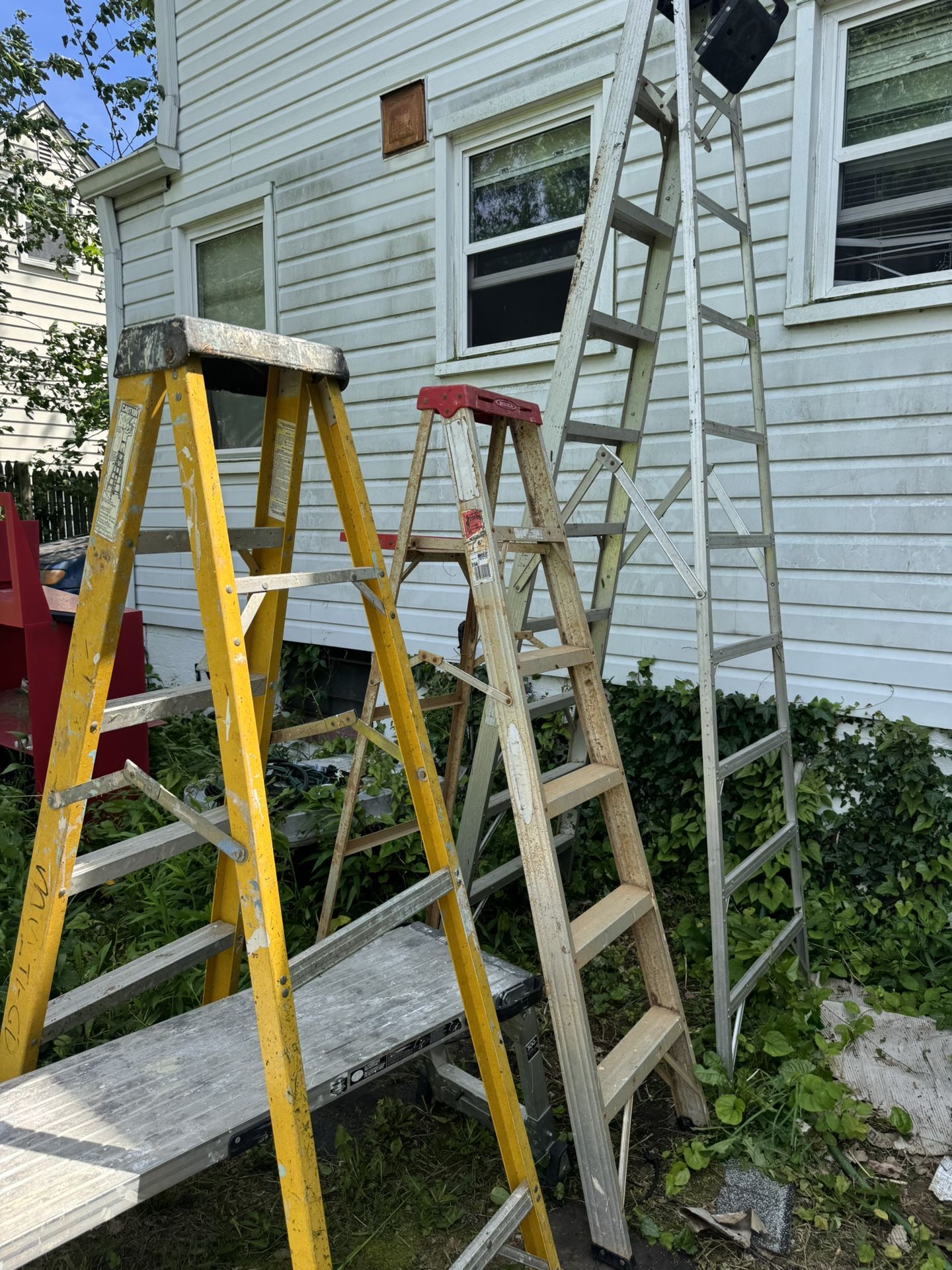 Various sized Extension ladders. and Step ladders Adjustable plank platform