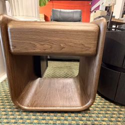 19 inches wide by 21 inches tall bedside table, made of dark walnut wood, exudes a warm and refined feel with its rounded shape. Its practical drawers