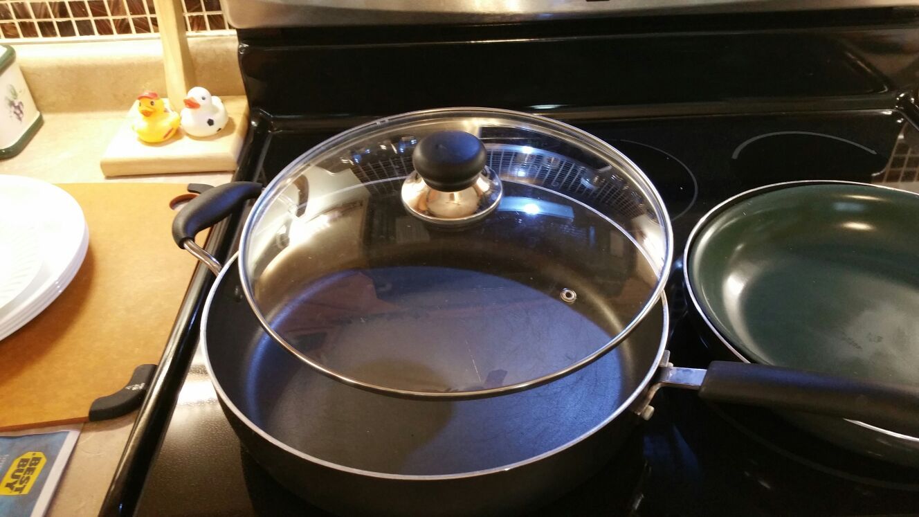 Large T-Fal frying pan two medium-sized frying pans one green frying pan