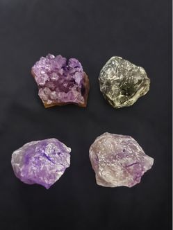 Natural raw crystal specimens include one amethyst cluster and three rough quartz pieces. The amethyst cluster has deep purple points on a brown matri
