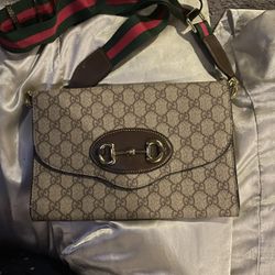 Gucci 1955 monogram horse bit mini bag with green and red strap so this is worth over $2000 online
