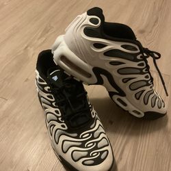Nike Air Max Plus Drift in the white, black, and metallic silver