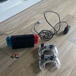 nintendo switch with games and wireless controllers 