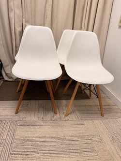 4 white Eames style dining chairs