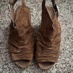 brown suede open-toe slingback booties with a ruched front and a large buckle strap on the side