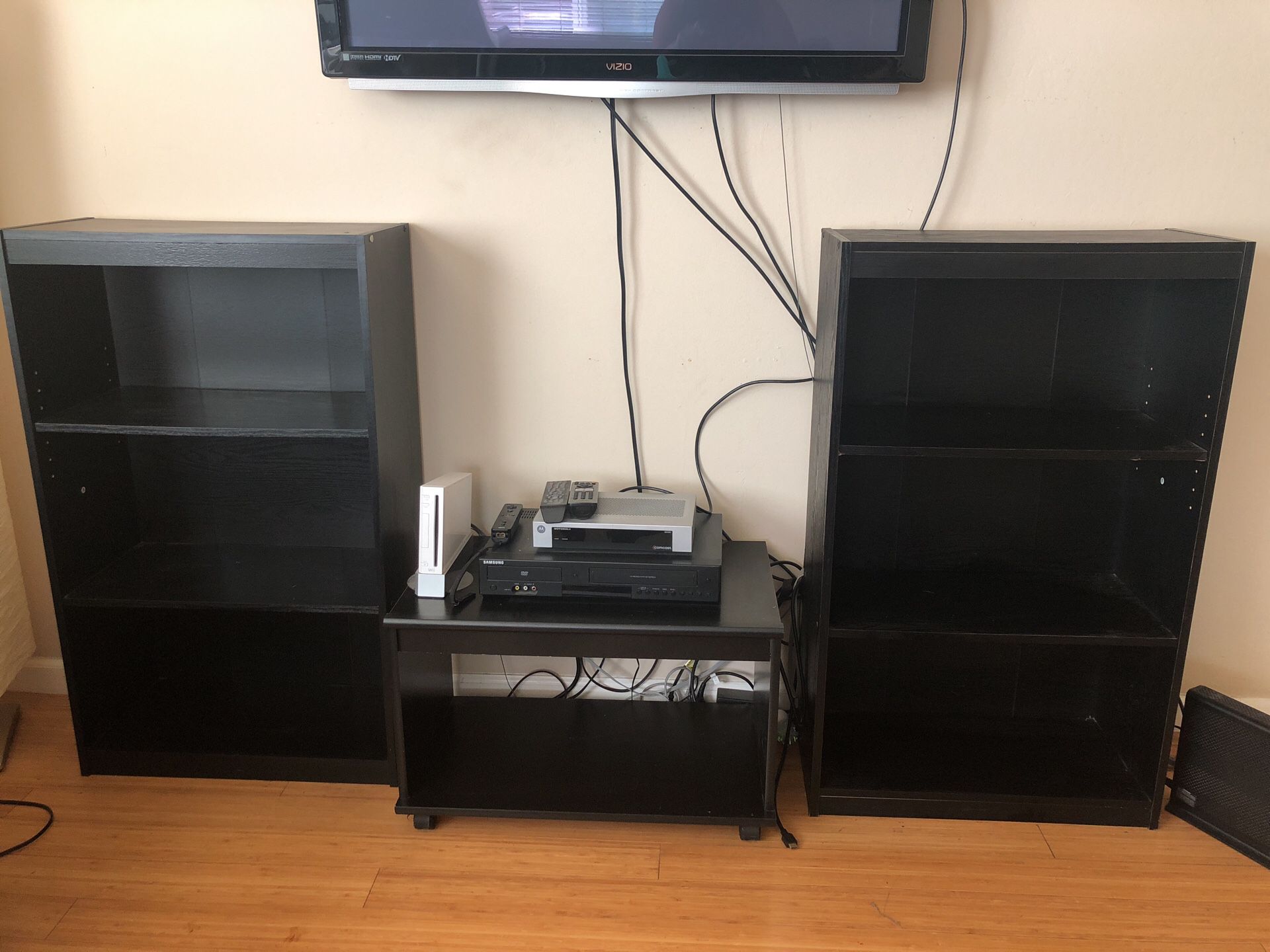 Two bookshelves with an entertainment box stand