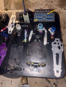 RC Car Parts Lot with Nitro Engines and Charger
