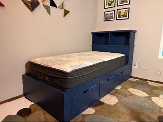 Description: Pottery Barn Kids twin storage bed in navy blue with built-in storage and mattress included.  Features: • 3 large pull-out drawers • Lift