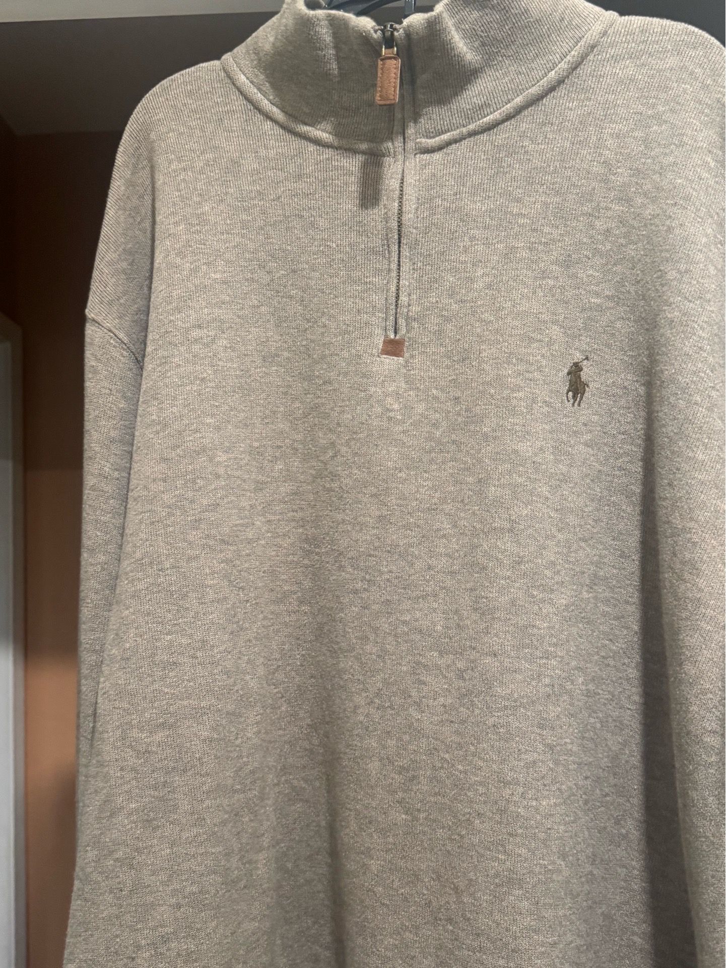 Ralph Lauren men's half-zip sweater. Soft knit with subtle embroidered polo logo. Zip neckline with leather pull tab. Versatile layering piece for eve