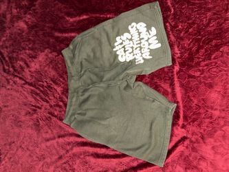 Green sweat shorts with white text graphic reading 'GATH RULES'
