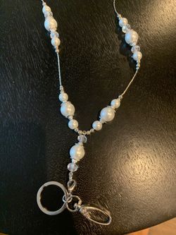 Pearl necklace with badge and key ring clip