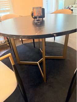 Black Faux marble top table w/ gold legs.