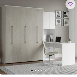 Wall bed with a desk