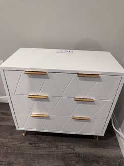 White dresser with electrical outlet