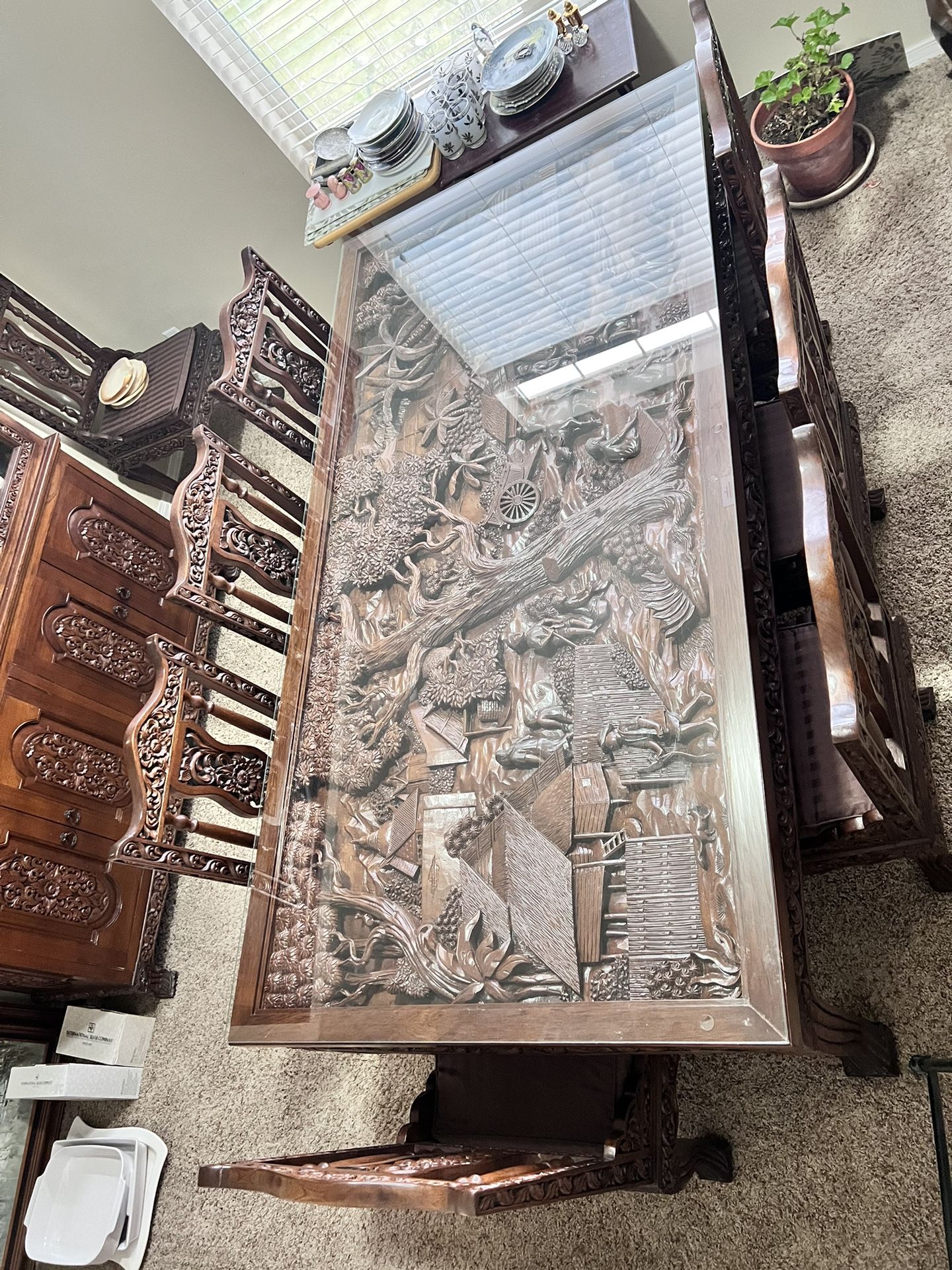 Vintage hand carved detailed Thailand village scene mahogany wood table with glass top, 8 hand carved chairs with cushions, hand carved glass/wood doo