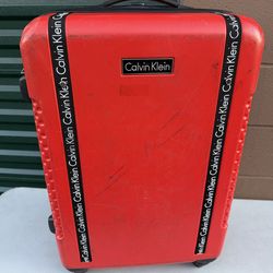 Red Calvin Klein Carry-On Suitcase Light Weight And Rolls Really Nice
