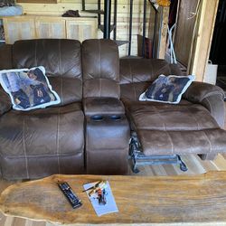 LOVE SEAT, Has Reclining Seats, Storage Compartment Between The Seats.  Brown Color, Kind Of Brushed Seidel 