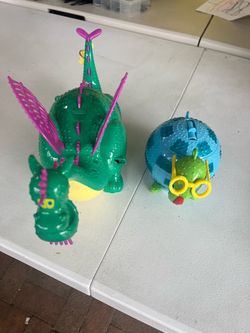 Disney Main Street Electrical Parade Elliott the Dragon light-up popcorn bucket and the matching turtle/snail sipper cup