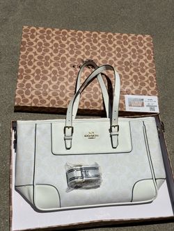 Coach Station Tote Bag features the brand's signature monogram canvas