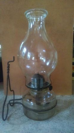 Old lamp with bracket to hang on wall.