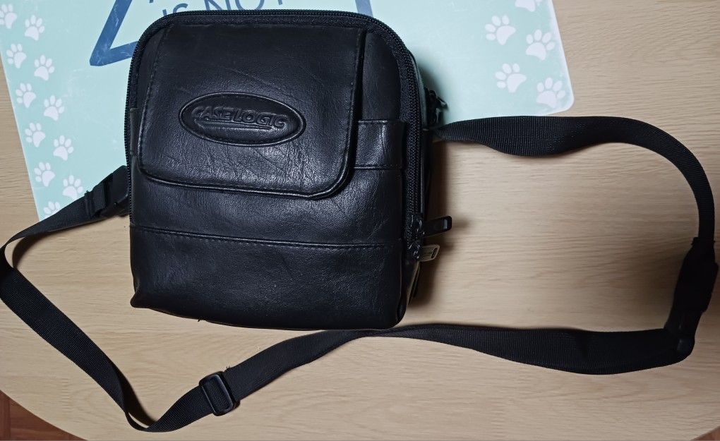 CASELOGIC BLACK LEATHER CAMERA CASE W/3 STORAGE COMPARTMENTS, STRAP & BAG OF EXTRA STRAPS & TAGS