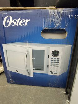 Oster 1.1 cubic 1000 watt microwave new in the box large box is dirty and damaged from being in stor