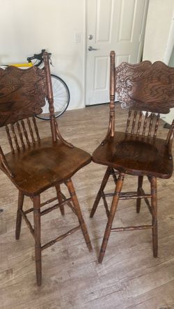 Two swivel bar chairs