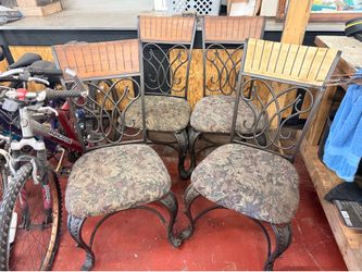 Set of four heavy wrought iron dining chairs