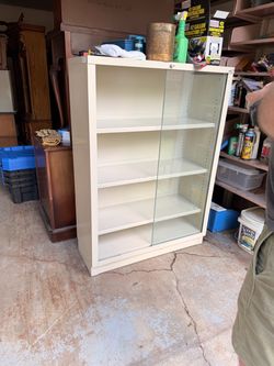 Metal shelf with glass sliding door