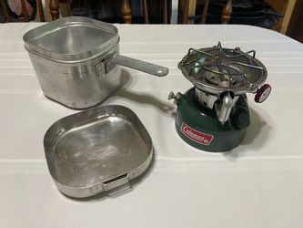 Coleman 502 stove with aluminum storage container and cooking pots