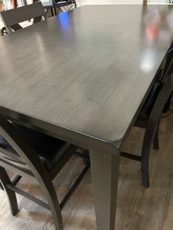 Counter height dining table  with 4 chairs. Like new! Sturdy, quality wood. 2 additional chairs available for $65 each. 36” x 60” x 36” high  Excellen