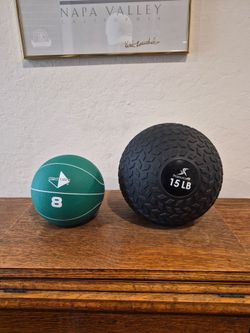 Set of two medicine balls: Century 8 LB and ProsourceFit 15 LB.